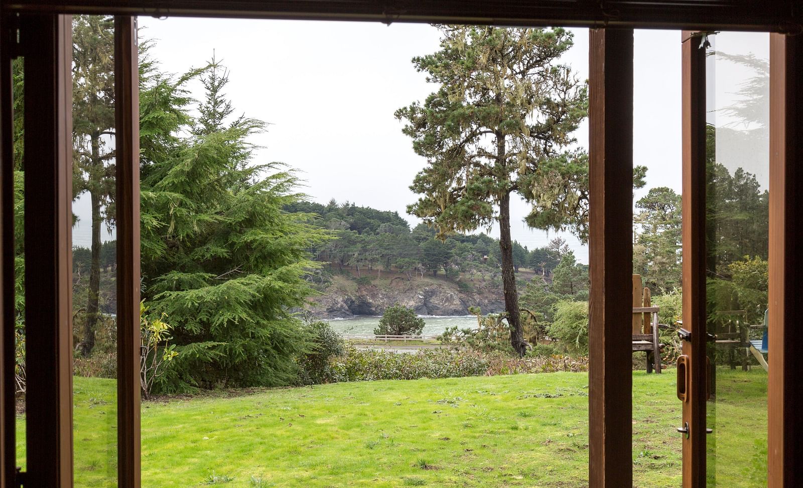 A breathtaking view of lush greenery through open French doors - Brewery Gulch Inn & Spa