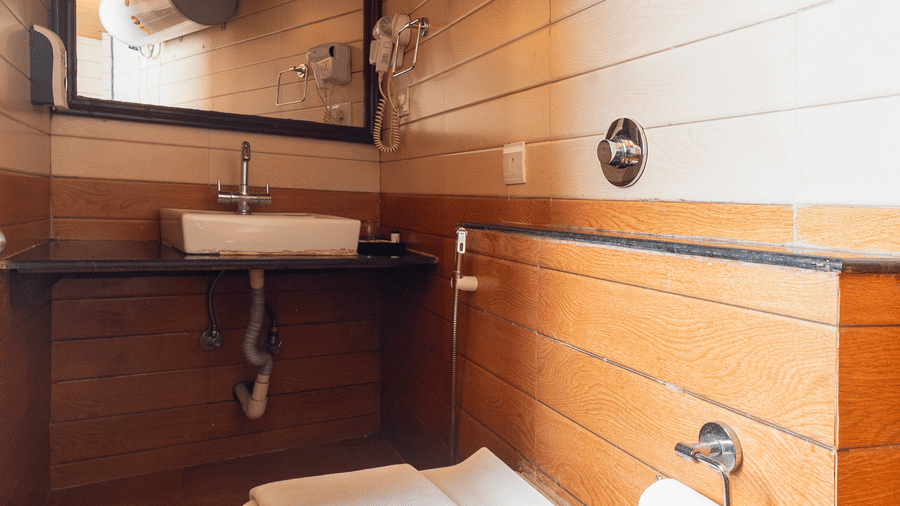 Luxury guest room at Sumitel Hotels with contemporary interiors, wooden textures, cozy bedding, ambient lighting, and refined decor inspired by mountain hospitality.