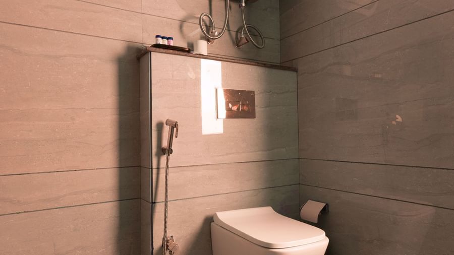 Bathroom at Sumitel Premier Inn, Siliguri, with WC, flush tank, and clean tiled interiors ensuring a hygienic and convenient guest experience.