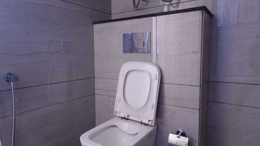 Bathroom at Sumitel Premier Inn, Siliguri, designed with modern fittings and a clean layout, featuring a wall-mounted flush and hygienic amenities.