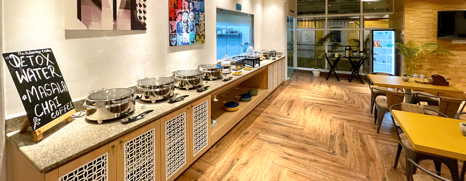 An interior Buffet Counter with seating and wooden flooring