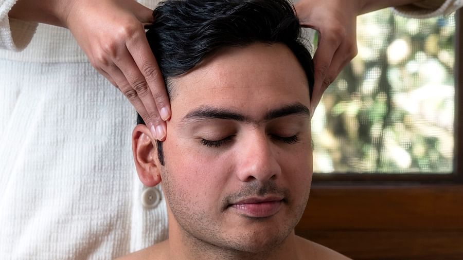 a person getting a head message at The Claridges Nabha Residence