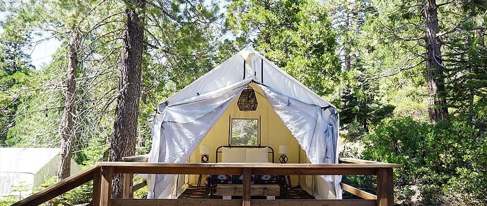 Exterior of a tent surrounded by trees at Shaver Lake Village Hotel.
