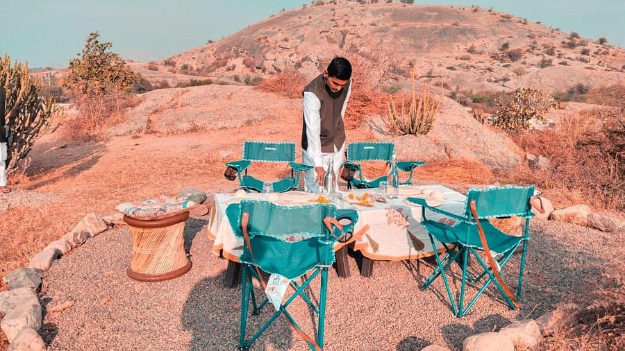 Clarks Safari Jawai - a person setting up a bonfire 