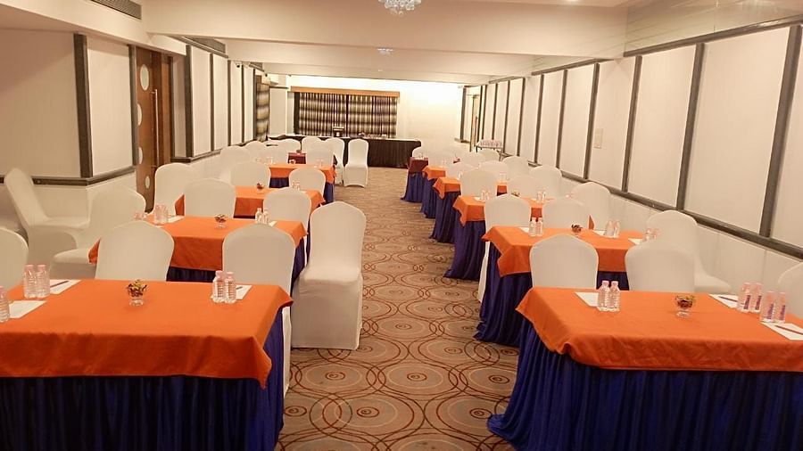 Event hall at Rang Lords Inn, set up with rows of chairs and decorated tables, prepared for a meeting or celebration