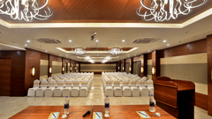 Theatre style seating arrangements with a desk on the podium inside the Banquet hall - VITS Devbhumi, Dwarka