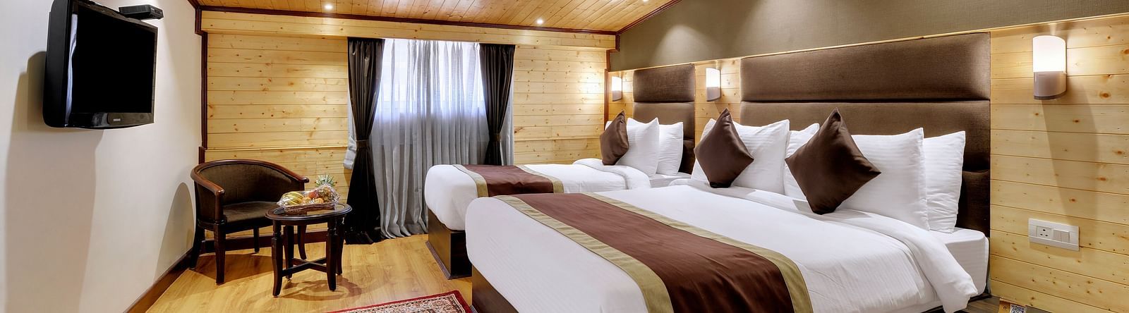 Image of a room with two large beds and a television in front-Sumitel Shangrila, Deorali