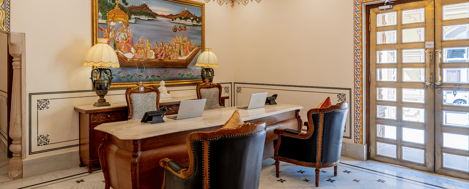 corner view image of the reception area with a beautiful mandala design engraved on the floor - Brij Castle, Jaipur