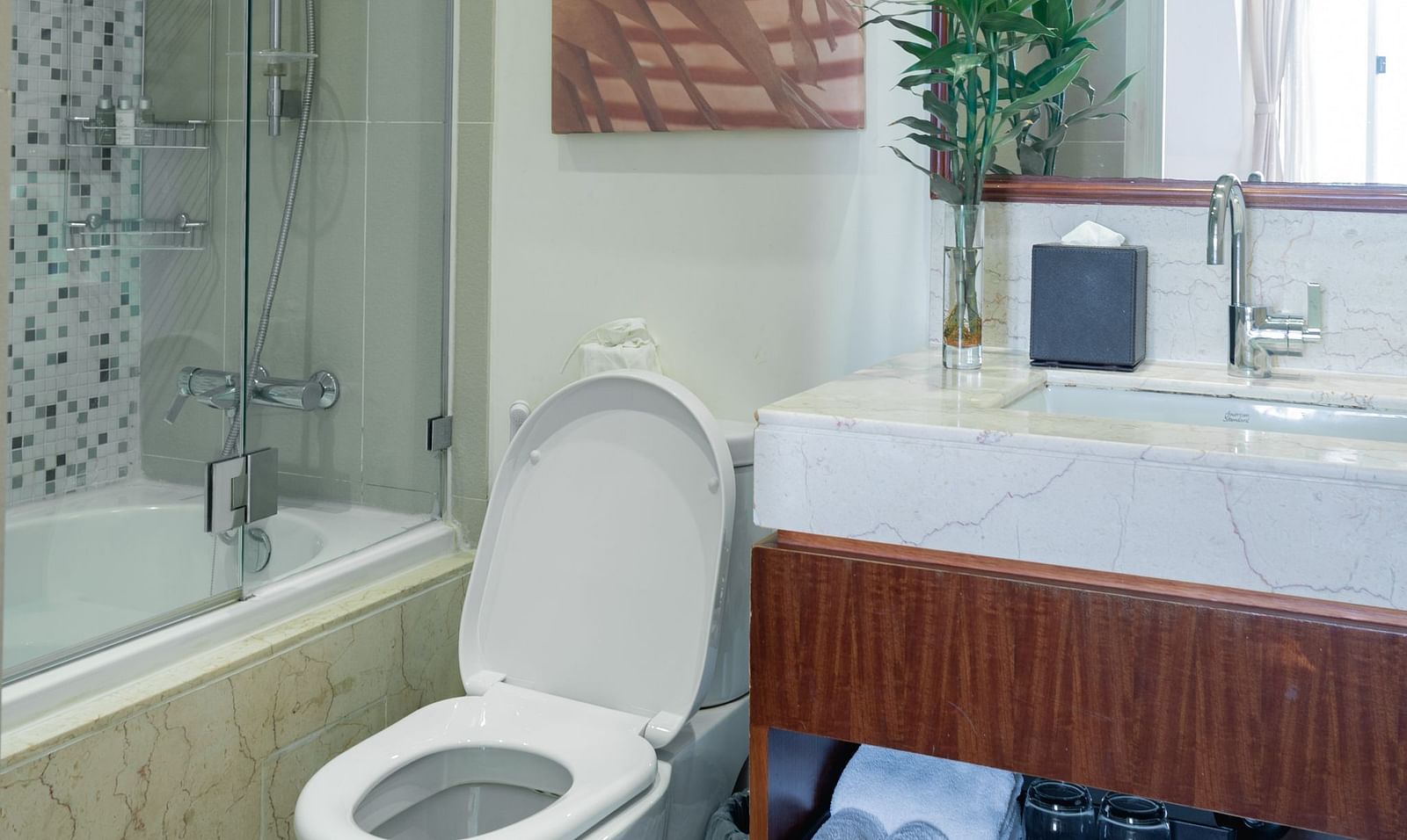 A bathroom with a toilet, sink, and a shower | Studio | Central Mansions, Phnom Penh