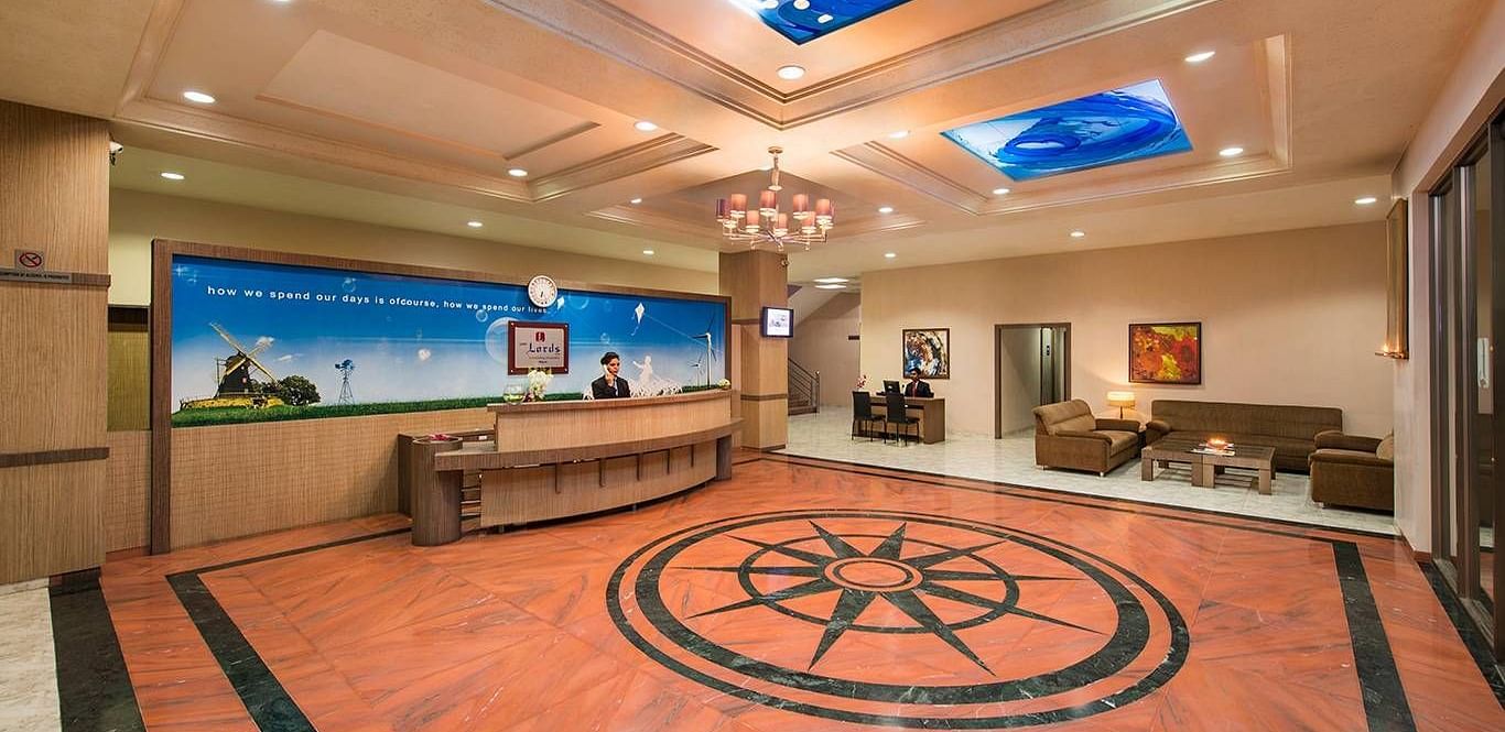 An ornate lobby features patterned flooring, comfortable seating, and unique lighting - Lion Lords Inn Rajula