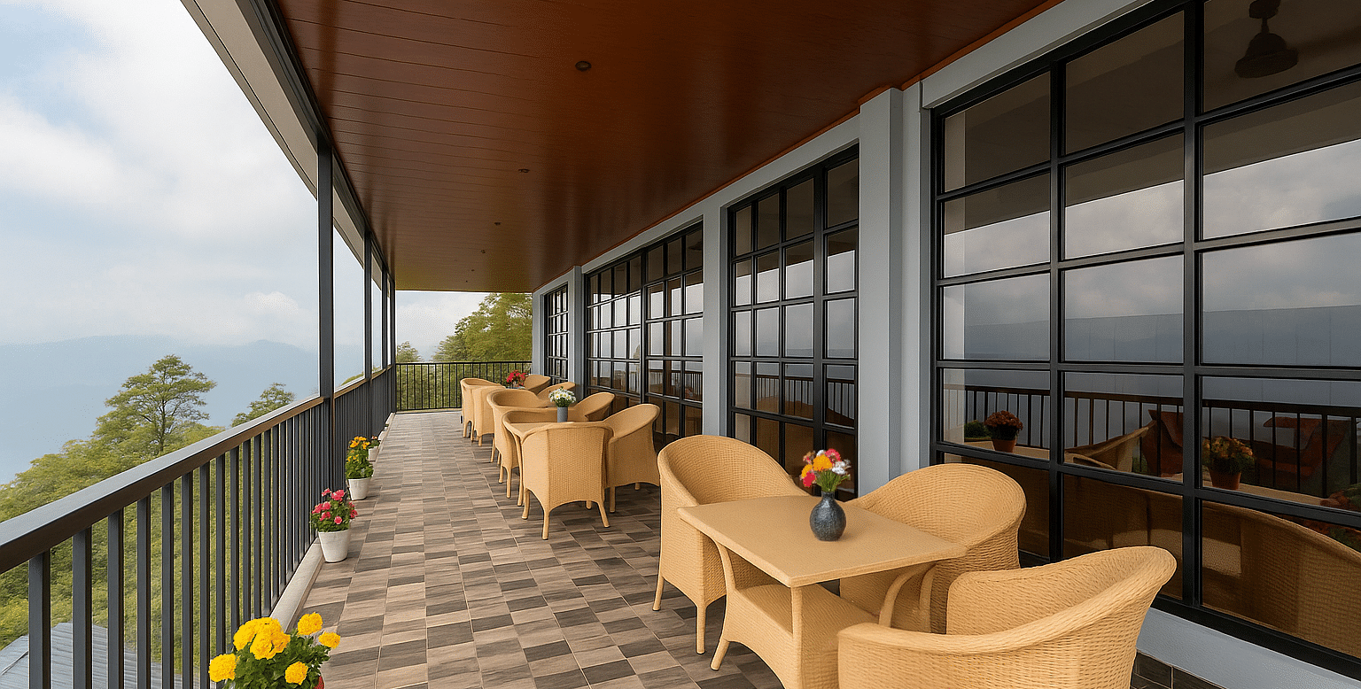 A scenic outdoor dining terrace at Summit Enigma Resort & Spa overlooks a mountainous landscape, featuring several tables with wicker chairs and potted flowers.