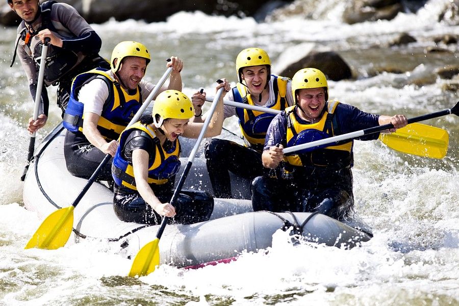 a group of people white water rafting