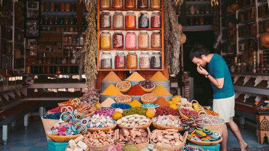 A vibrant display of various colourful spices and dried goods in a traditional market setting at Ananta Express, Katra.