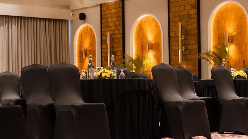 Ballroom with elegantly arranged chairs, complemented by floral carpets that adds a touch of luxury