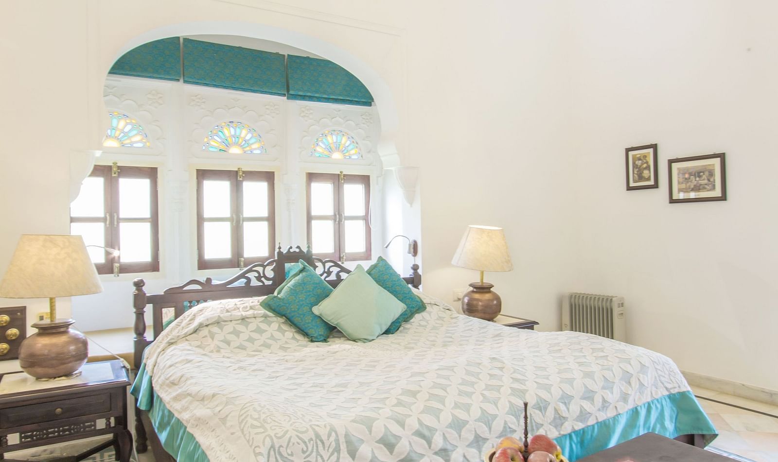 image of a bedroom with a double bed with white coloured walls at dev shree, deogarh