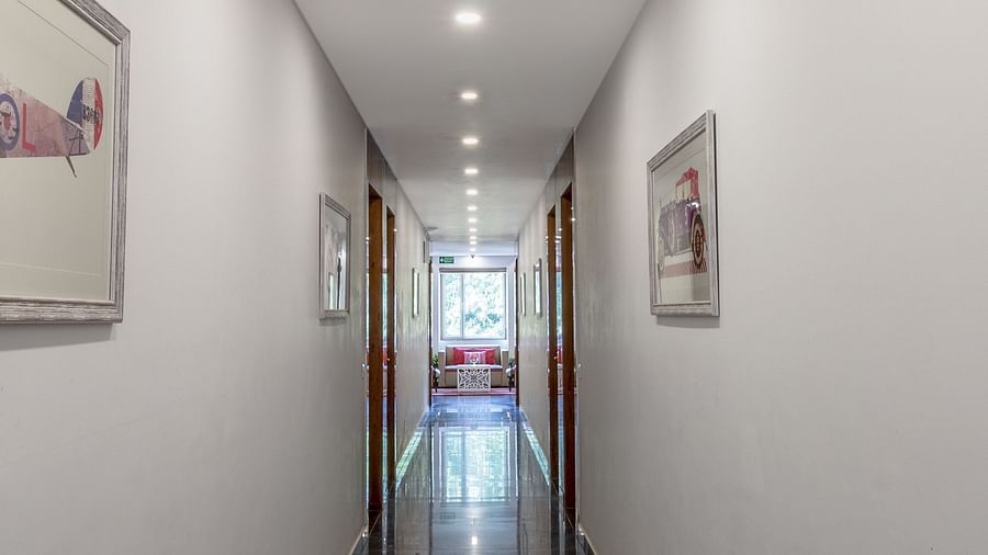 Image of a corridor with paintings hanging on wall at Inde Hotel Cyber City 