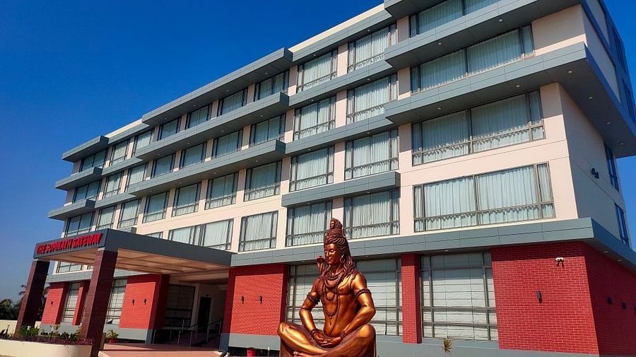 An image of the enormous hotel with lord shiva statue at the front 