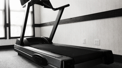a black and white image of a treadmill at the fitness centre at Hotel Marine Plaza Mumbai