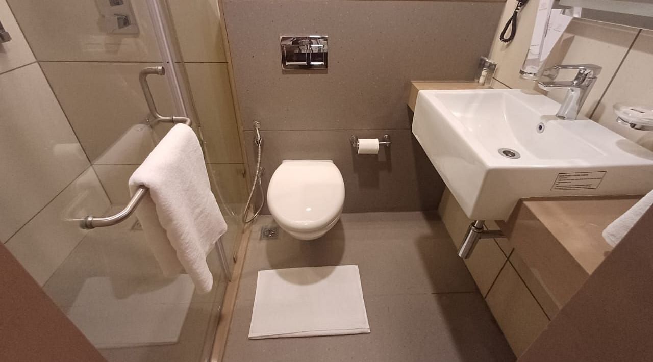 Image of a restroom with modern amenities at Hotel Raai, Hosur.