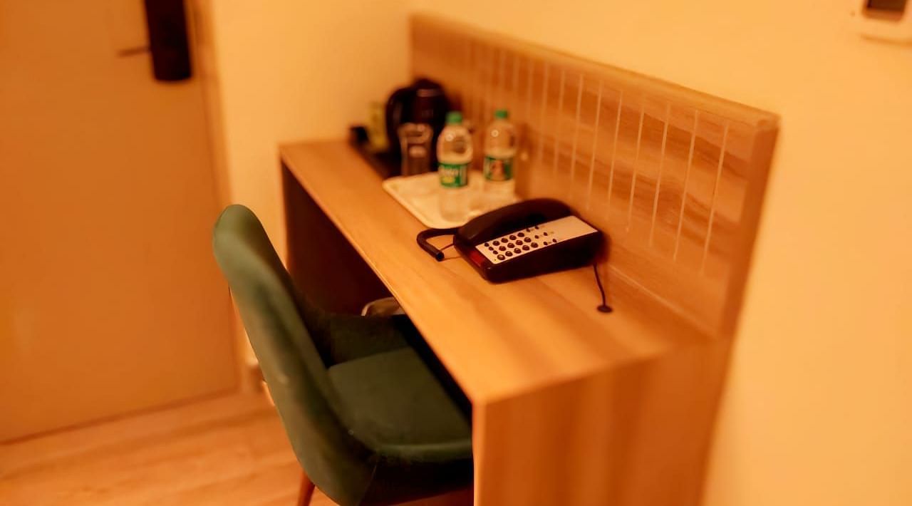 Image of a room with study area equipped with a chair and a table.