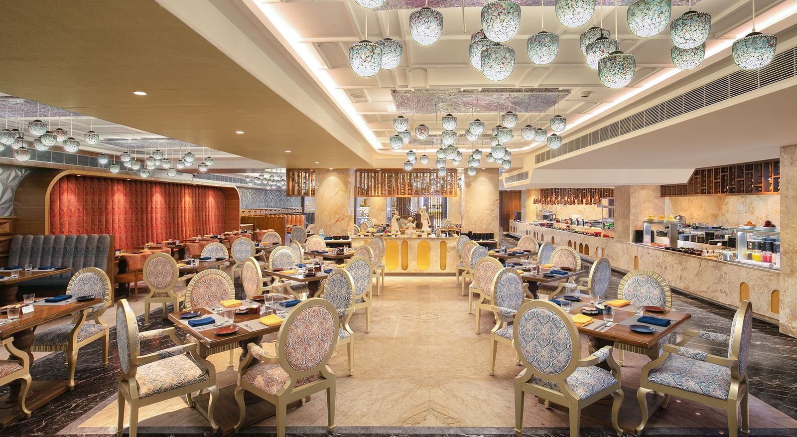 A spacious dining hall featuring modern decor and warm lighting - Kaldan Samudhra Palace