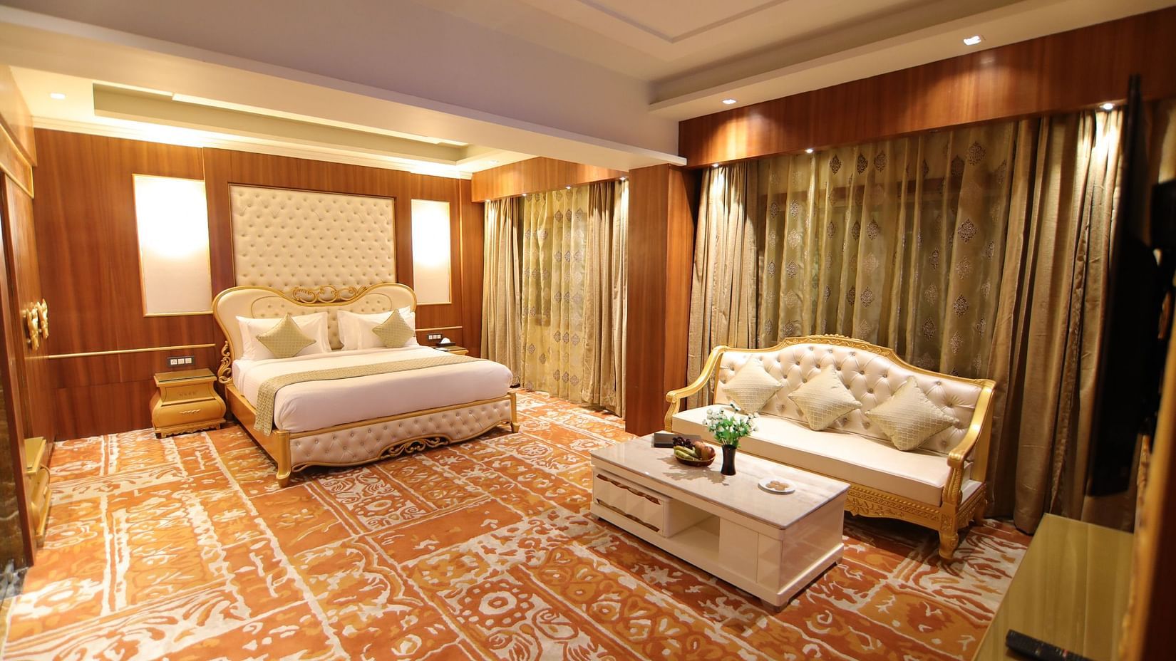 The Royal Suite featuring a bed and a white sofa