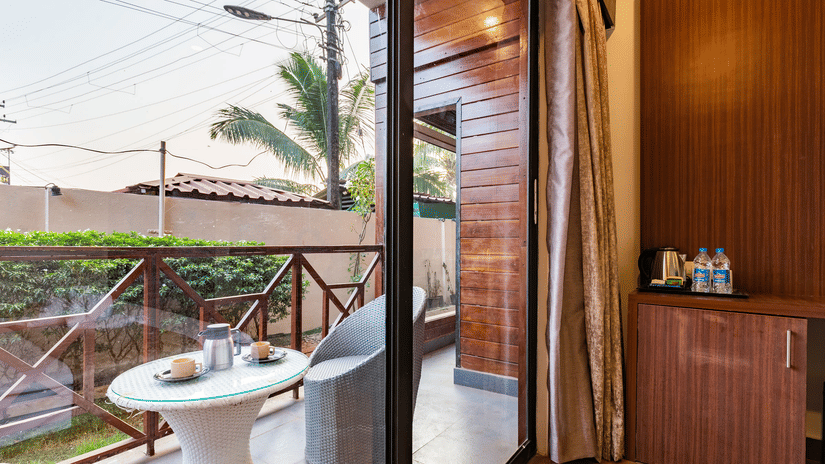 The balcony of the Amara Premium Room furnished with a seating area for two, views of the outdoors.