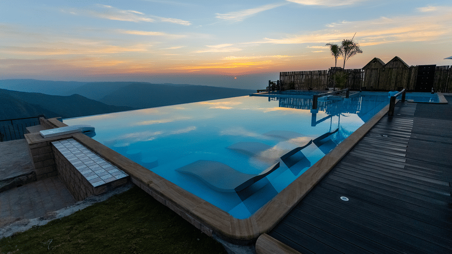 Infinity pool overlooking sunset and mountains - Polo Resort Cherrapunji