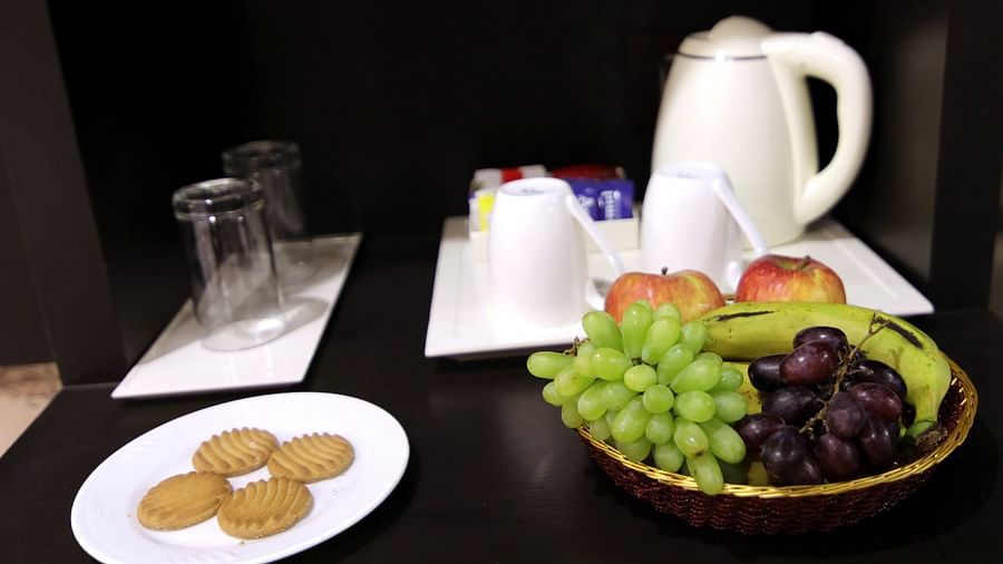 Teacups, fruits and biscuits arranged on the table - Deluxe Room 3 - Udman Hotel Haridwar