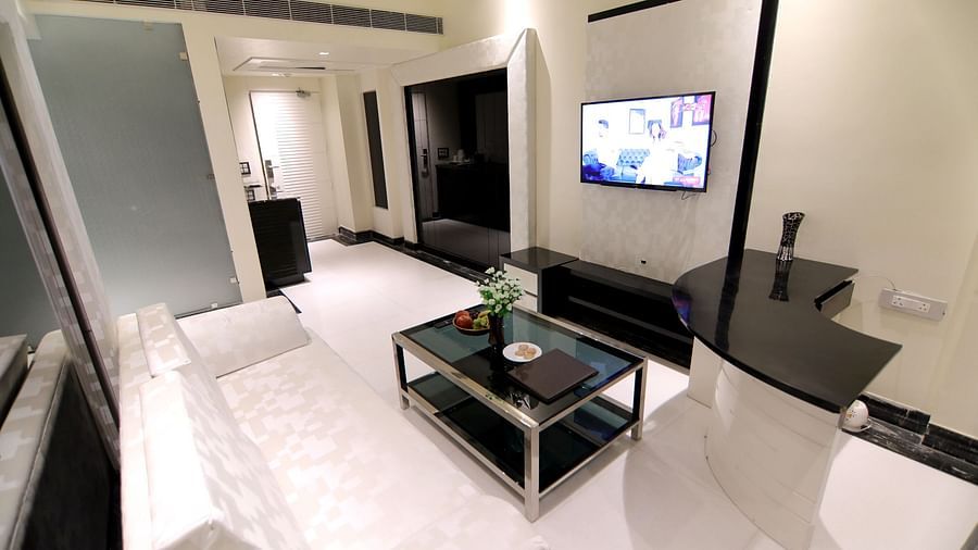The white sofa and TV at the Junior Suite - Theme Modern 1 - Udman Hotel Haridwar