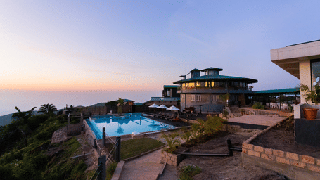 Evening exterior view of Polo Resort Cherrapunjee with infinity pool.