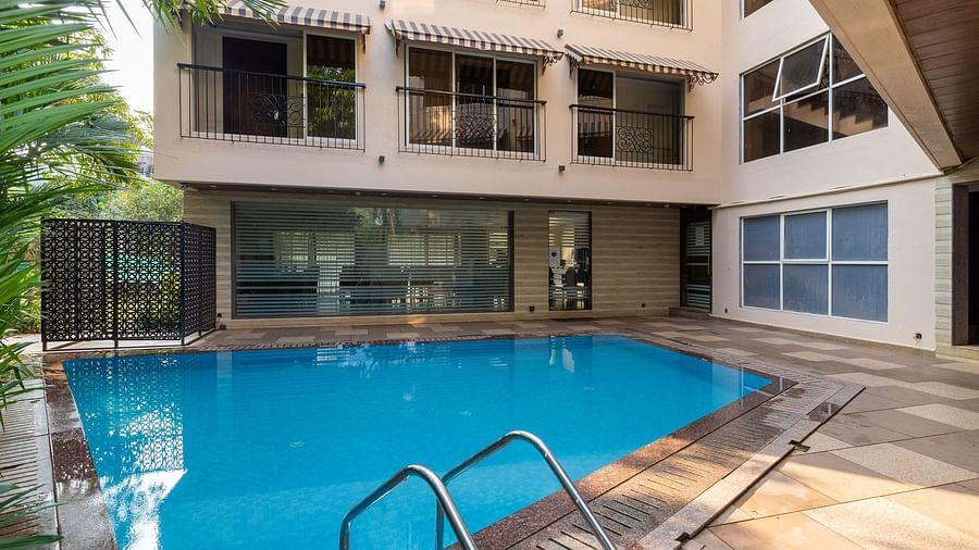 Image of a swimming pool with a building in the background at Calux Grand Inn, Calangute.
