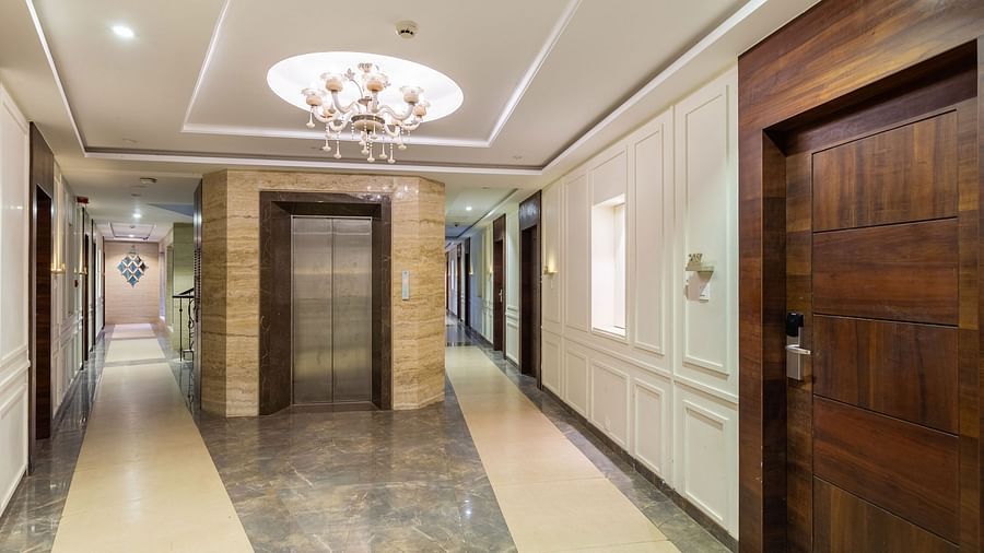 Image of a hallway with a lift in between at Calux Grand Inn, Calangute.