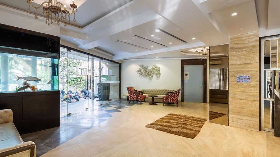 Image of a lobby with an aquarium and a seating area in the corner at Calux Grand Inn, Calangute.