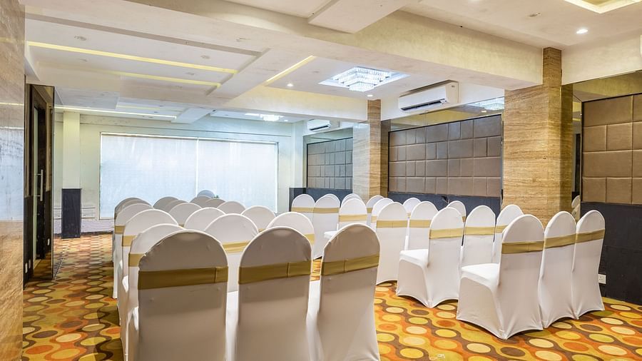 Back view of a banquet hall with chairs at Calux Grand Inn, Calangute.