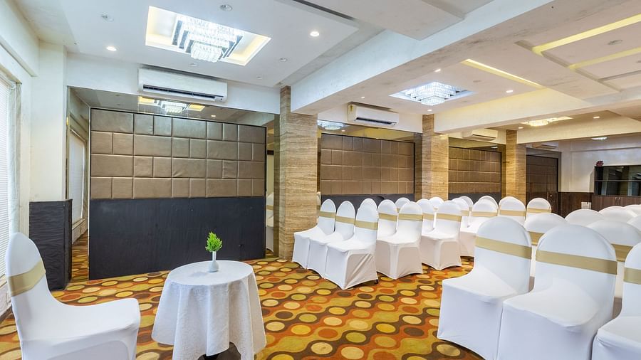 Image of a banquet hall with chairs neatly arranged at Calux Grand Inn, Calangute.