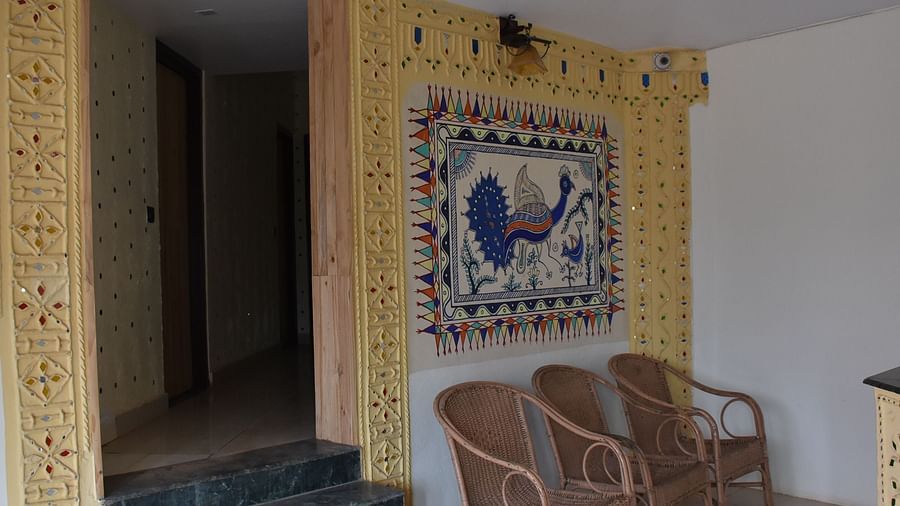 The reception area at Riverside Inn, featuring chairs placed beside the wall and a doorway leading inside.