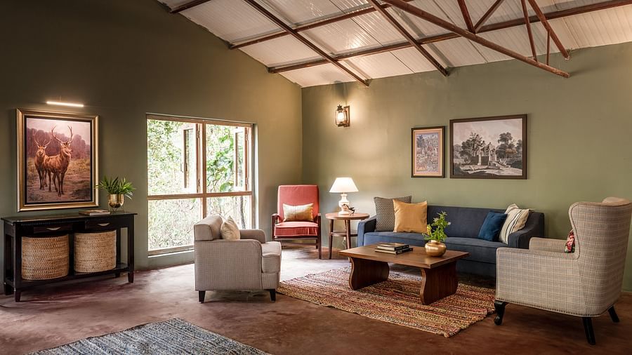 Interior of the Coffee Lounge with multiple sofas at Saccharum Safari Lodge, Balaghat