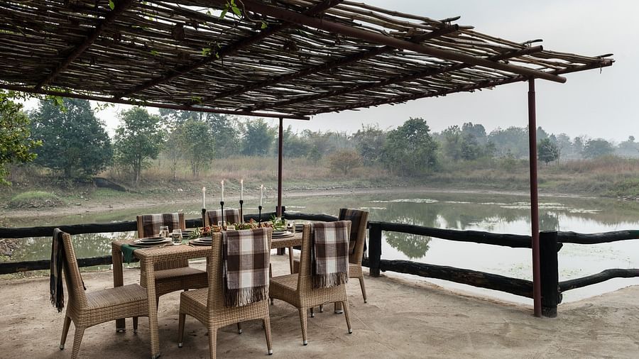 Dining setup near Swimming Pool at Saccharum Safari Lodge, Balaghat