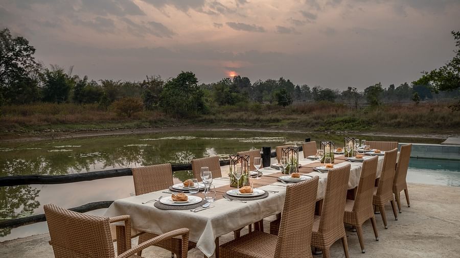 Side view of the dining setup Swimming Pool at Saccharum Safari Lodge, Balaghat