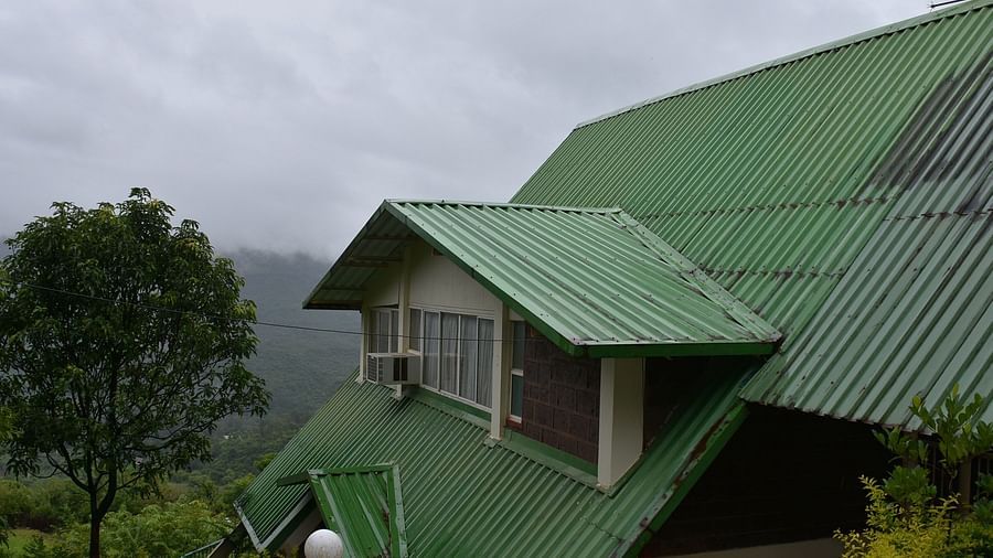 View of the roof of Wind Chalet Resort, surrounded by lush trees in the background.
