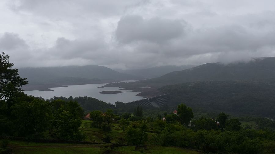 View of Koyna Dam, surrounded by misty mountains.