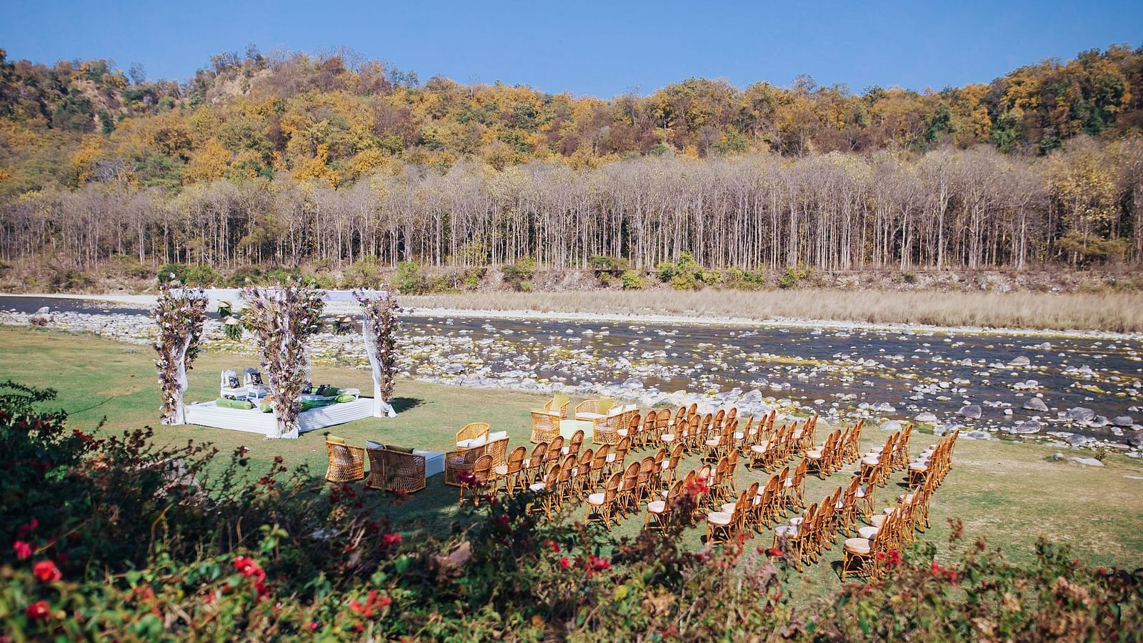  An image of a outdoor banquet hall with chairs and a stage decorated for destination wedding halls - Riverview Retreat, Corbett