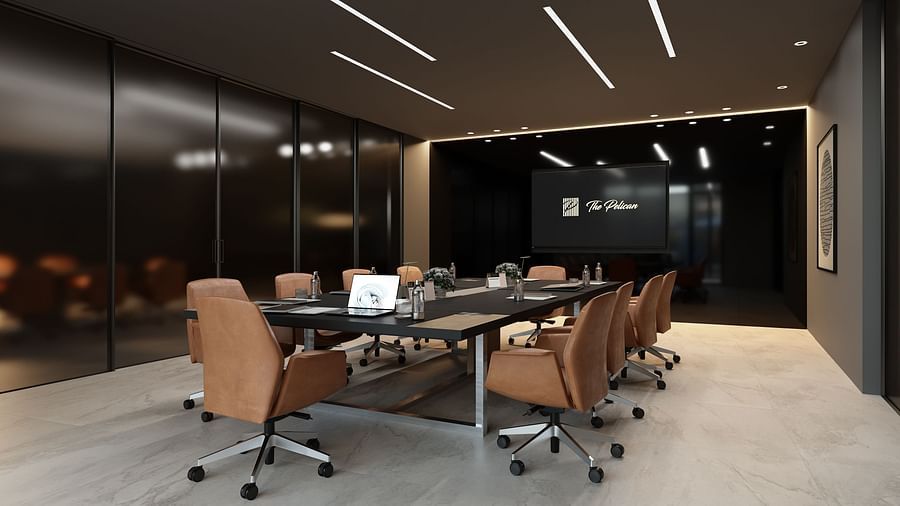 A boardroom meeting area with a large table surrounded by chairs at The Pelican Hotel, Accra.