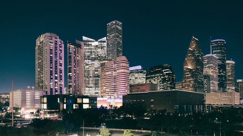 IT Park with multiple buildings at night time with a garden in front of it