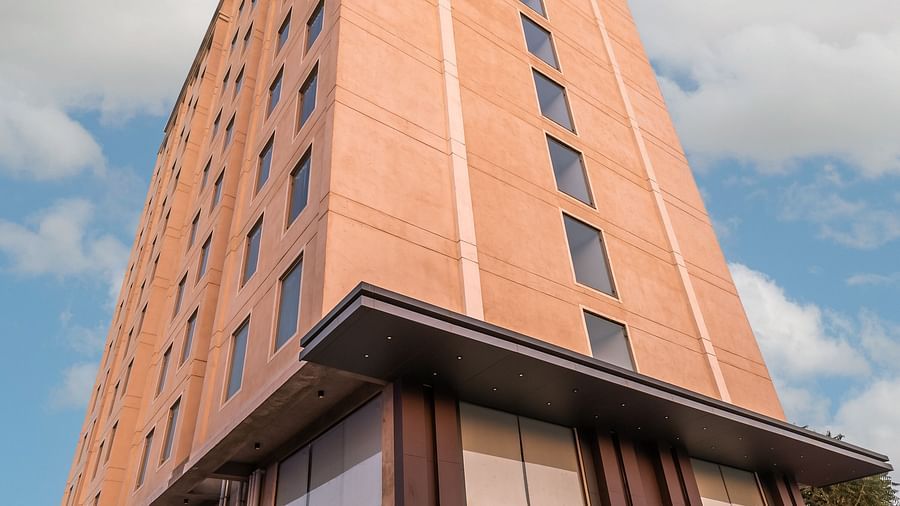 Facade of Clarks Inn Suites Jaipur, Ajmer Road under a blue sky featuring its entrance to the hotel 