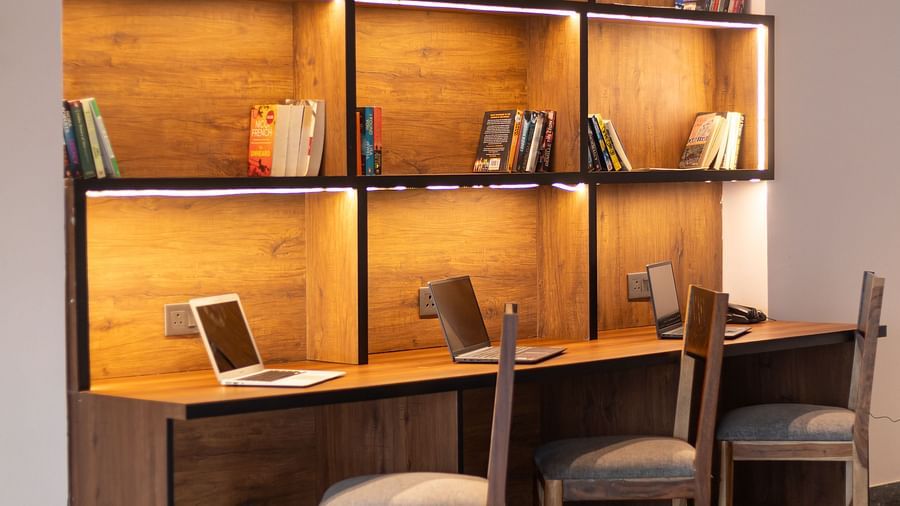Lobby at Clarks Inn Suites Jaipur, Ajmer Road featuring a dedicated work space with a desk with laptops on it, three chairs