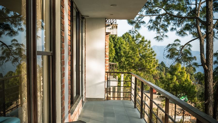 A suite balcony featuring a comfortable resting chair with a scenic view at A suite balcony featuring a comfortable resting chair with a scenic view.