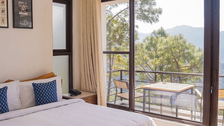 A bedroom featuring balcony at BluSalzz Escapade Resort, Lansdowne