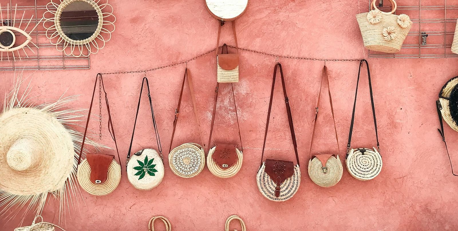 Handicraft bags and mirrors placed near the wall for aesthetic looks.